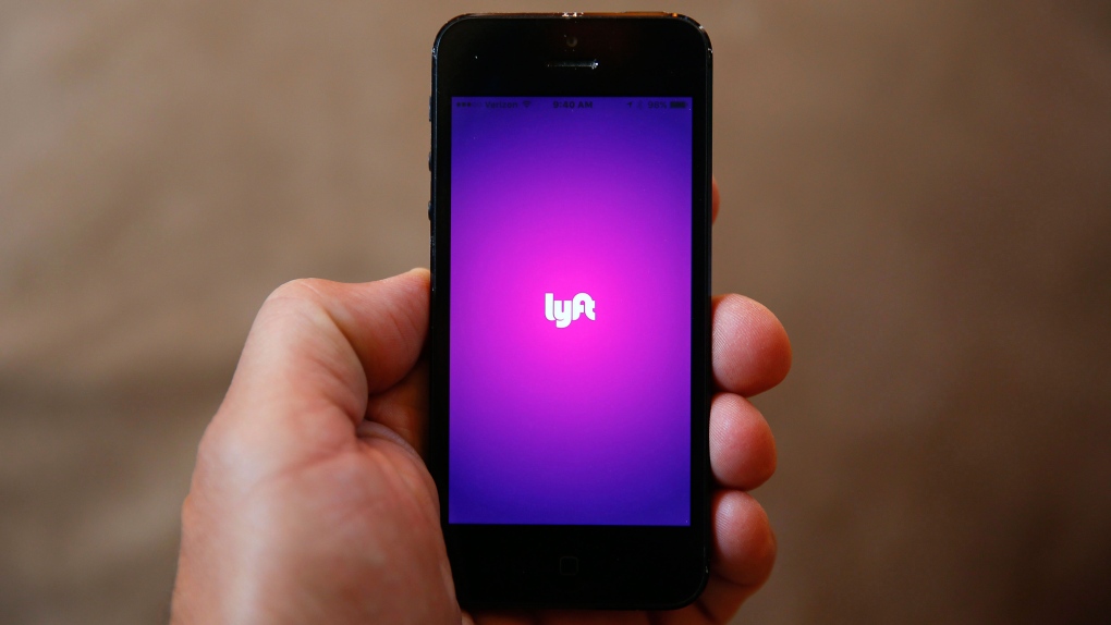 This Monday, May 16, 2016, file photo shows a smartphone displaying the Lyft app, in Detroit. (AP Photo/Paul Sancya, File)