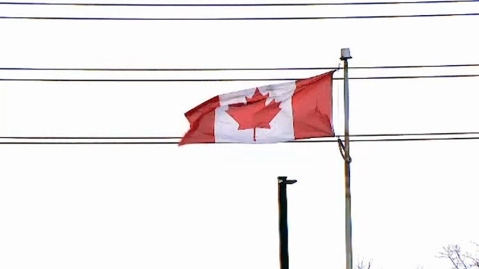 Canadian flag blowing in strong winds