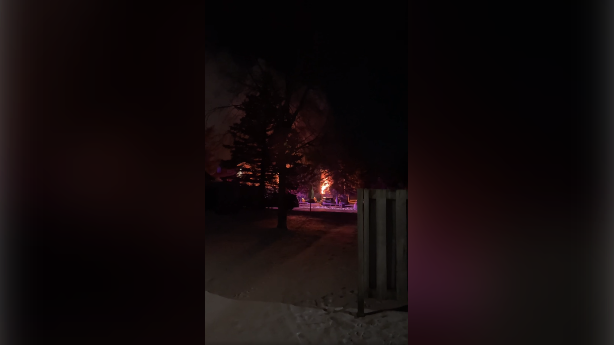Townhouse unit fully engulfed in flames Friday night. (Tieler Barnes / Facebook) 