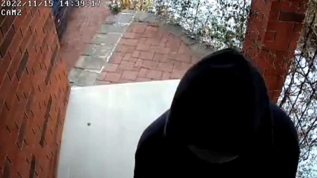 A security camera still shows someone forcing open the door of a Kitchener home. (Submitted/Waterloo regional police)