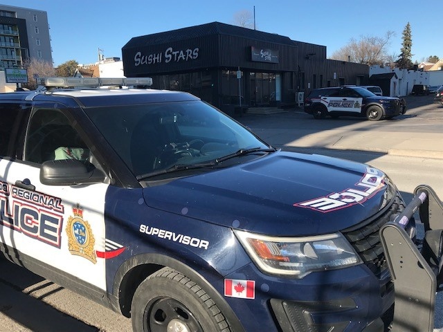 Police cars are seen on King Street in downtown Kitchener following a stabbing on Dec. 4, 2022. (Dave Pettitt/CTV Kitchener)