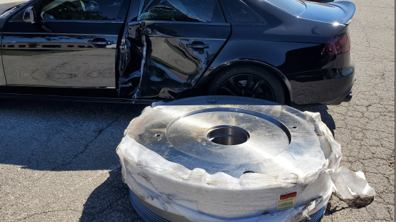 A metal part, weighing 10,000 lbs, fell of a commercial vehicle and rolled into a parked car on Trillium Drive in Kitchener on June 23, 2022. (Submitted: WRPS)
