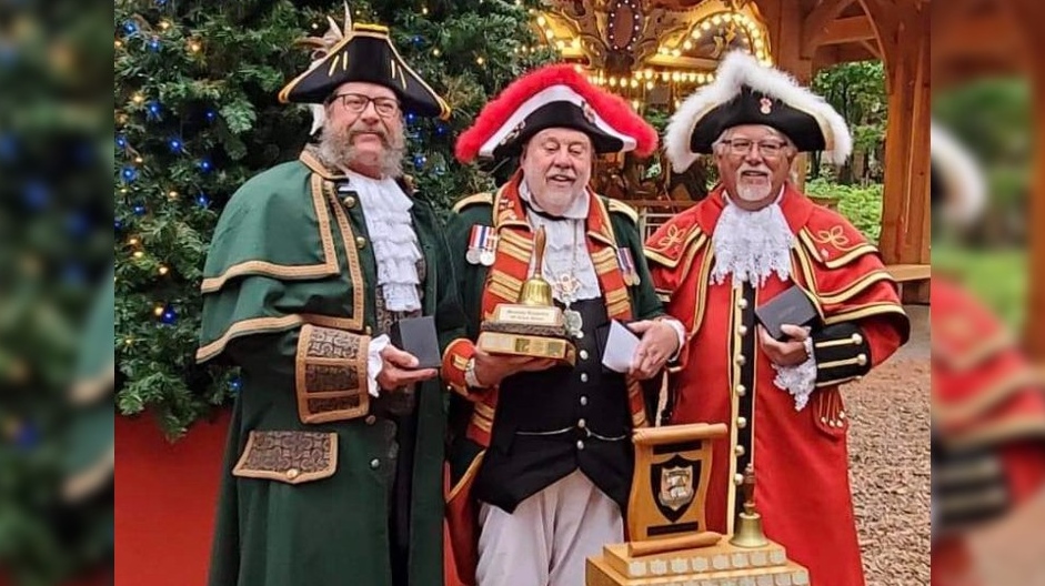 David McKee, Brantford’s Official Town Crier (pictured middle) holds the trophy for first place in the Ontario Guild of Town Criers Provincial Championship. He stands next to Chris Whyman, City of Kingston Town Crier (pictured right) who placed second and Liam Craig, Township of Alnwick/Haldimand Town Crier (pictured left) who placed third. (Submitted/City of Brantford)