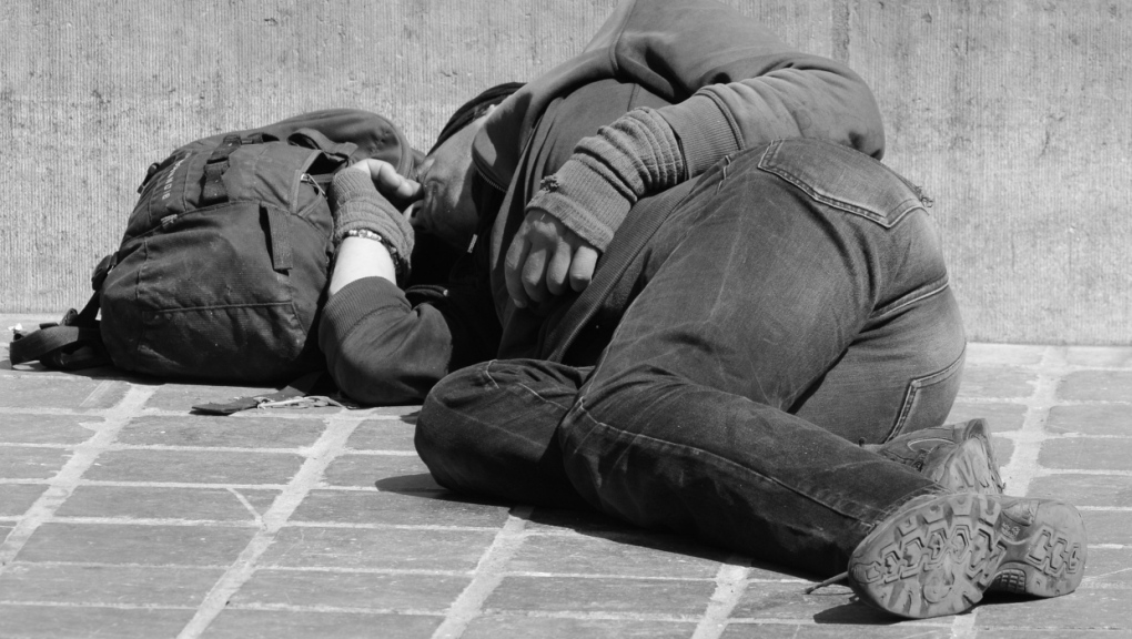 A stock photo shows a man experiencing homelessness sleeping on the street. (Pixabay/Ben Kerckx) 