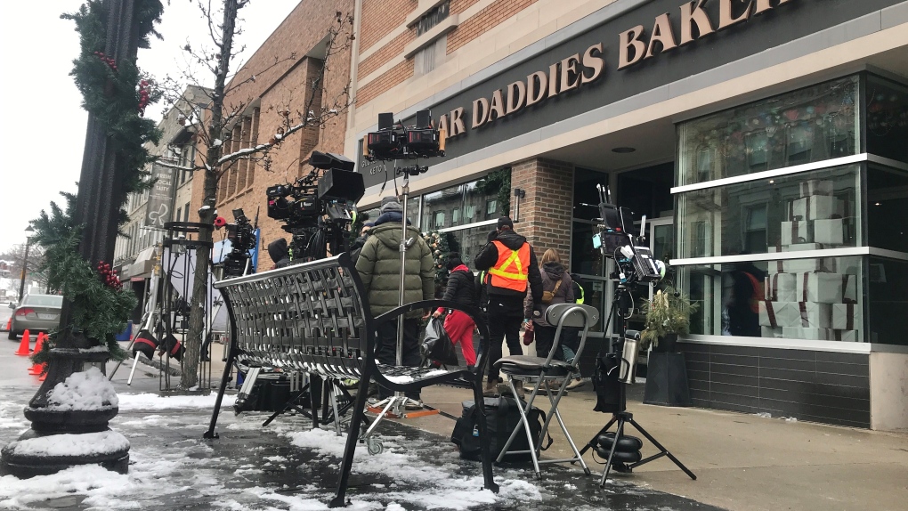 A production crew films scenes for a made-for-tv Christmas movie outside of Sugar Daddies Bakery on Main Street in downtown Cambridge. (Dan Lauckner/CTV News Kitchener)