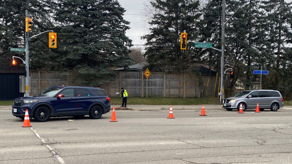 A police vehicle and a damaged SUV appear at the intersection of Northfield Drive and Westmount Road in Waterloo on Nov. 24, 2023 where a pedestrian was hit. (Brandon Guitar/CTV Kitchener)