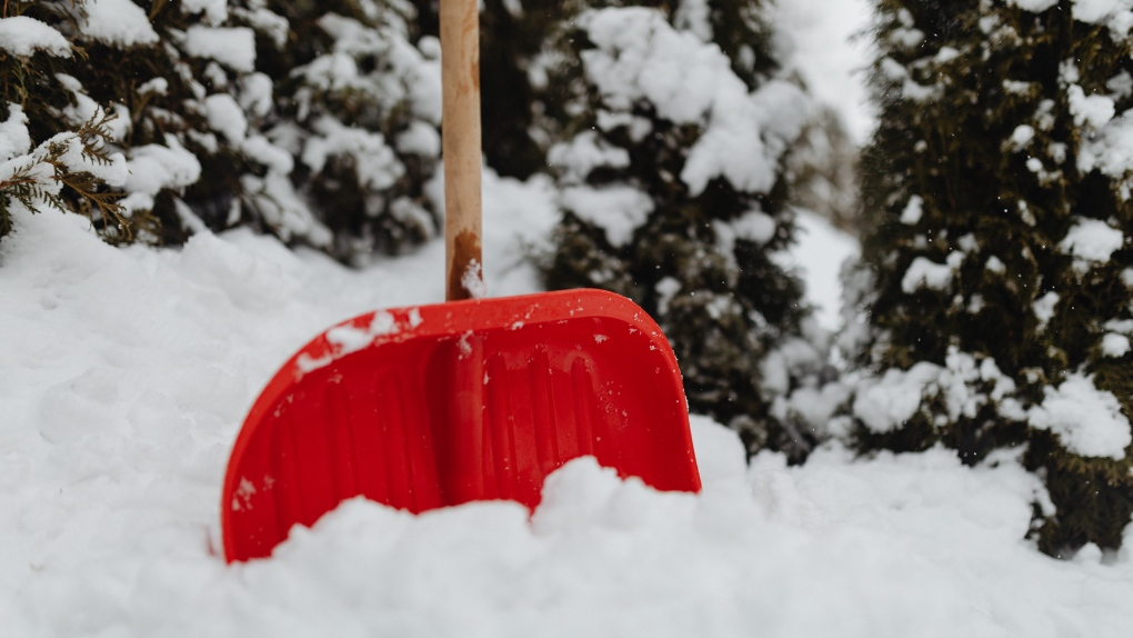 A snow shovel is seen in a pile of snow. (Pexels/Karolina Grabowska)