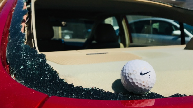 A golf ball in a smashed rear windshield